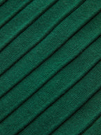 Green ribbed knit vest with diagonal raised lines and subtle metallic accents on cap sleeves.