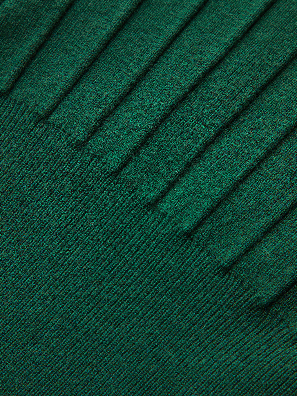 A dark green ribbed knit vest with metallic detail and distinctive cap sleeves.