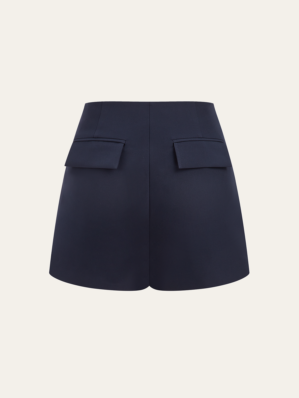 Asymmetrical metallic accent skort with high waist and unique back flap pockets detailing.
