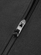 Black velvet corset with metallic zipper pull, visible teeth, and contrasting piping detail.