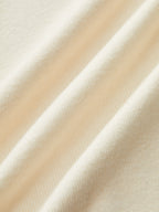 Cream-colored sweater dress with long sleeves, soft texture, subtle folds, and contrast trim details.