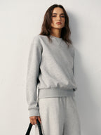 Light gray LA FINE FLEUR cotton blend crew neck sweatshirt and matching sweatpants set.
