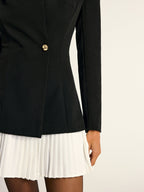 The LA FINE FLEUR blazer dress has gold buttons and a white pleated skirt panel.