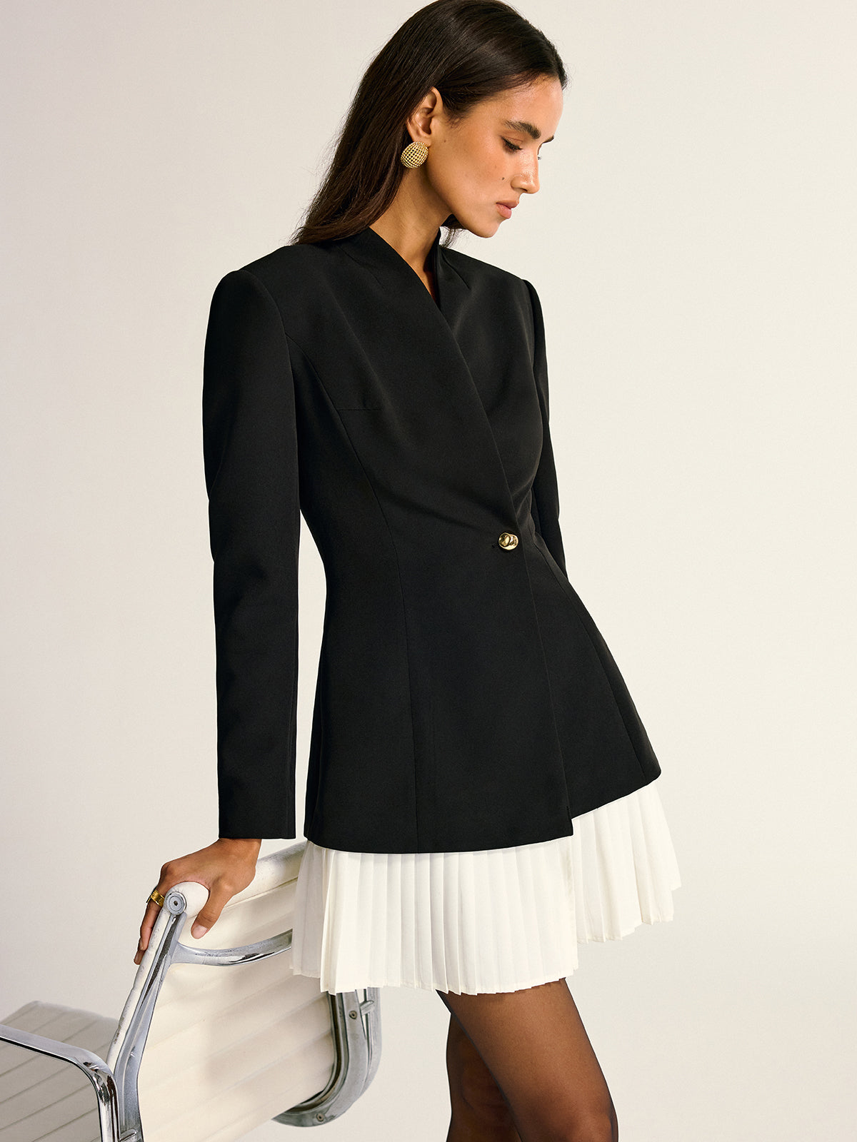 A tailored blazer dress in white with woven pleated accents and a single button.