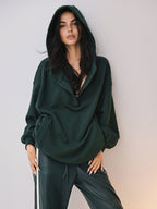 Dark green cozy large hoodie with buttons and hood, paired with matching faux leather wide-leg pants.