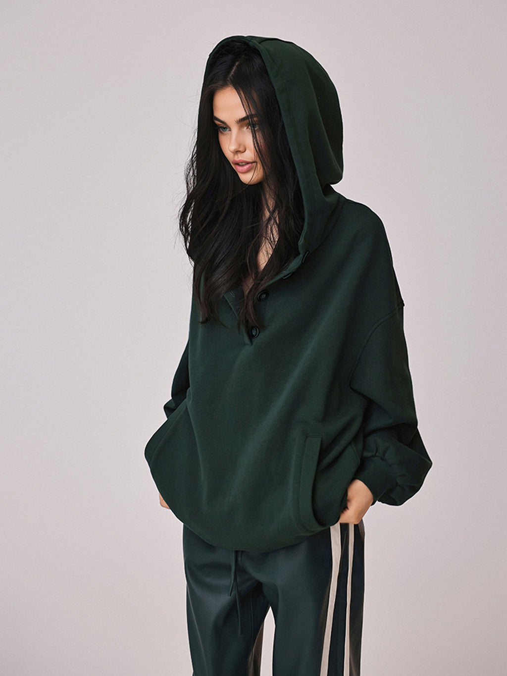 The LA FINE FLEUR Cozy Large Hoodie features buttons and an attached hood.
