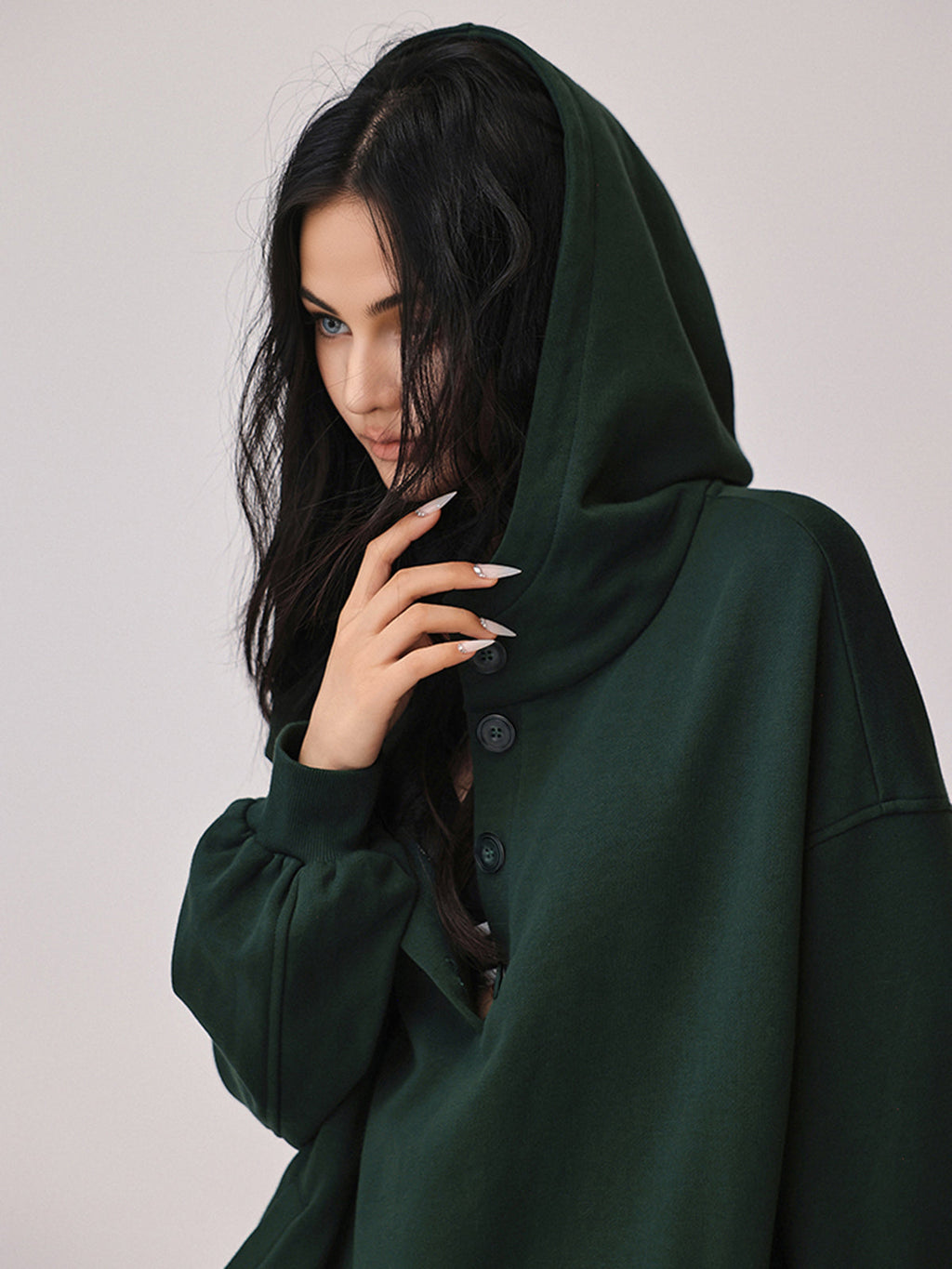 Cozy large hoodie with buttons and attached hood, featuring a relaxed, comfortable fit.