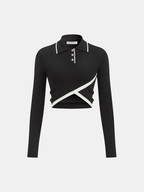 Black slim-fit polo crop with long sleeves, buttoned neckline, white trim, and diagonal stripe.