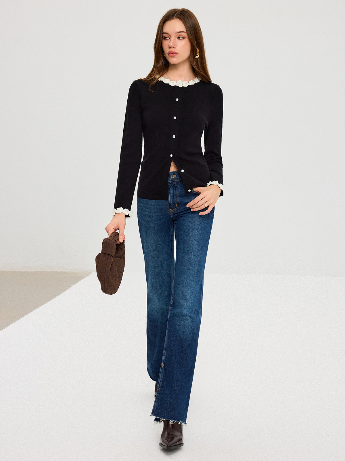 LA FINE FLEUR 3D floral embroidered cardigan with pearl buttons, paired with blue jeans.