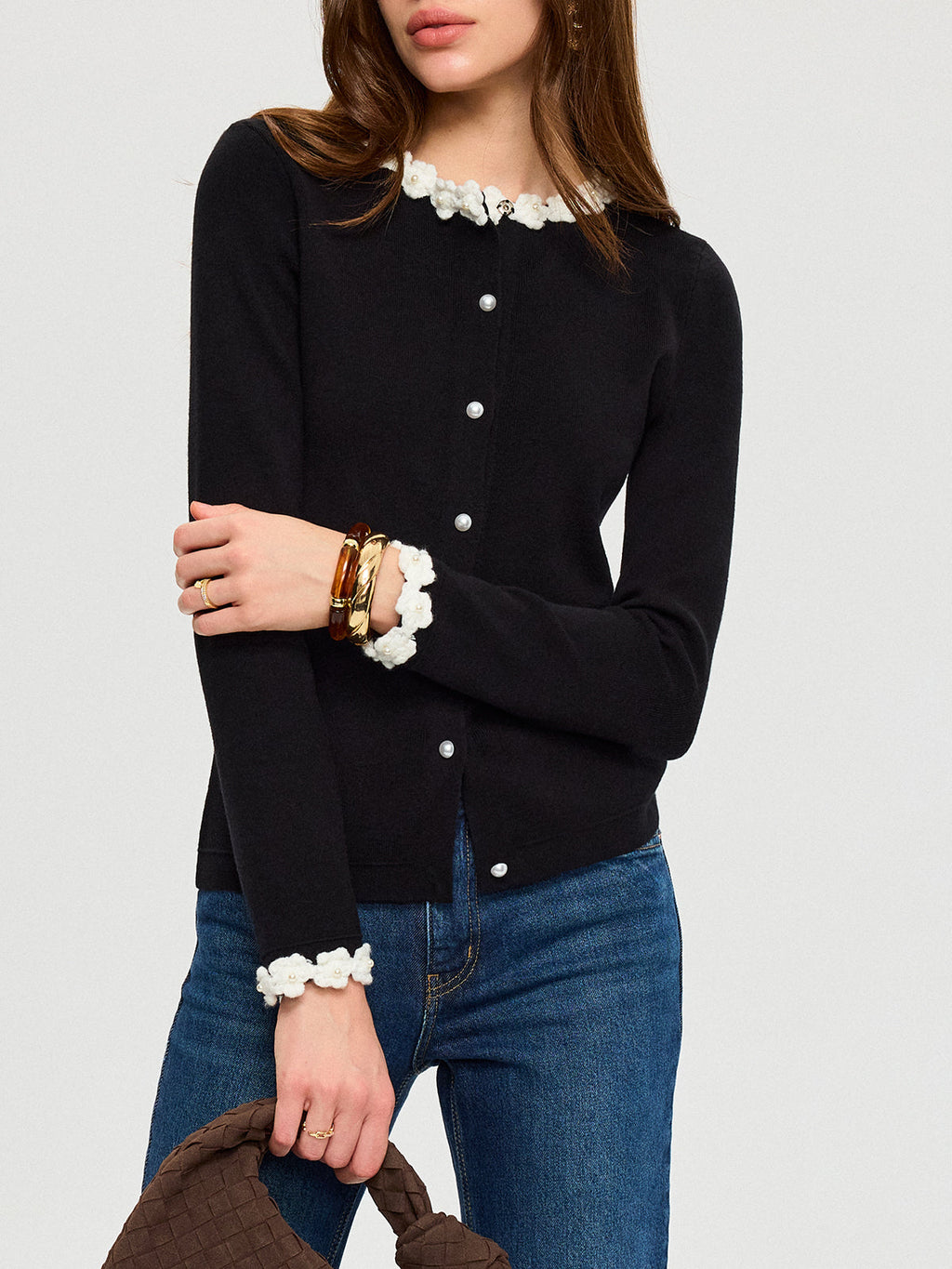 The LA FINE FLEUR 3D Floral Embroidered Cardigan with Elegant Pearl Buttons and blue jeans.