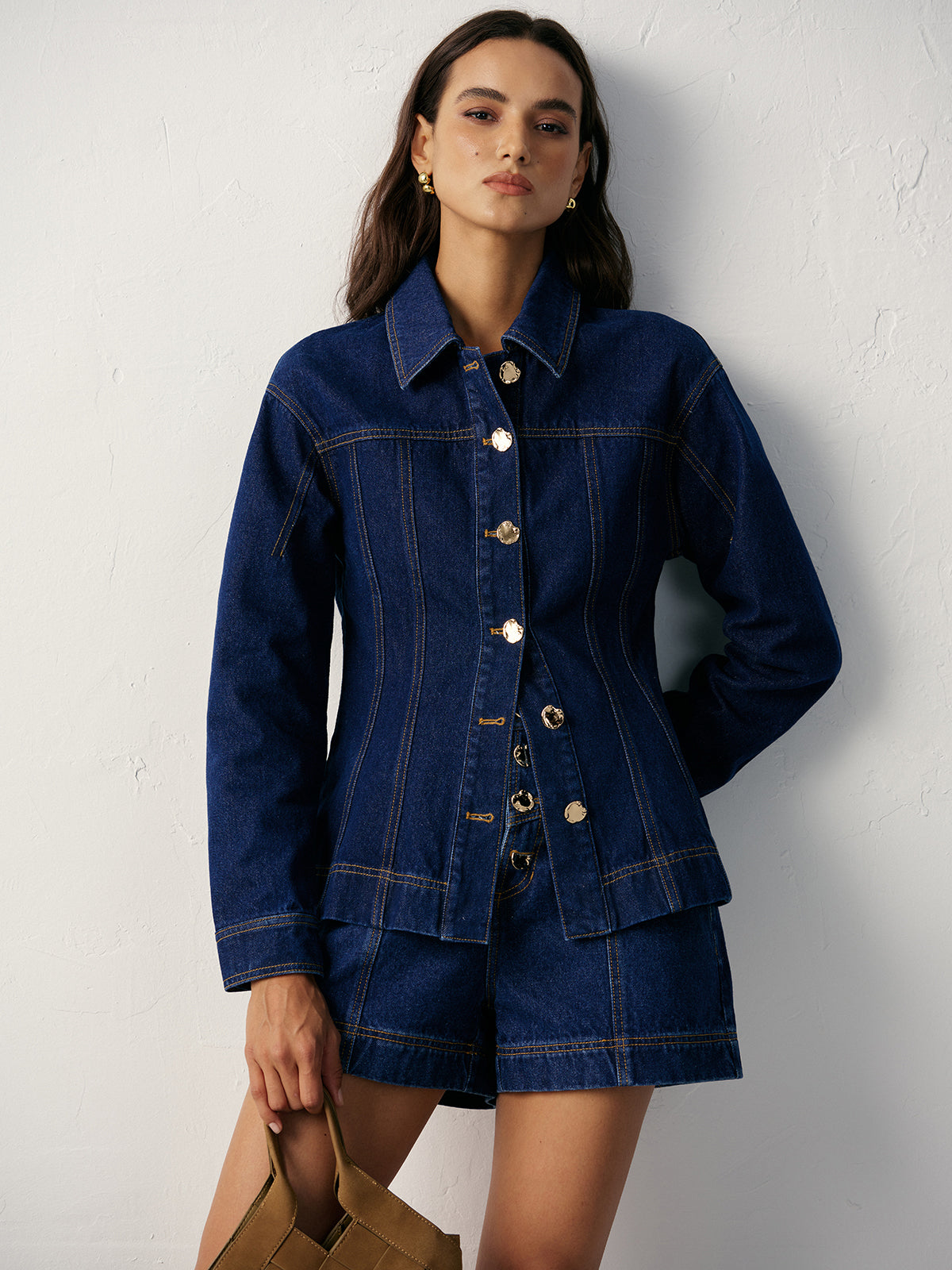 A fitted denim jacket with metal buttons paired with matching regular fit denim shorts.