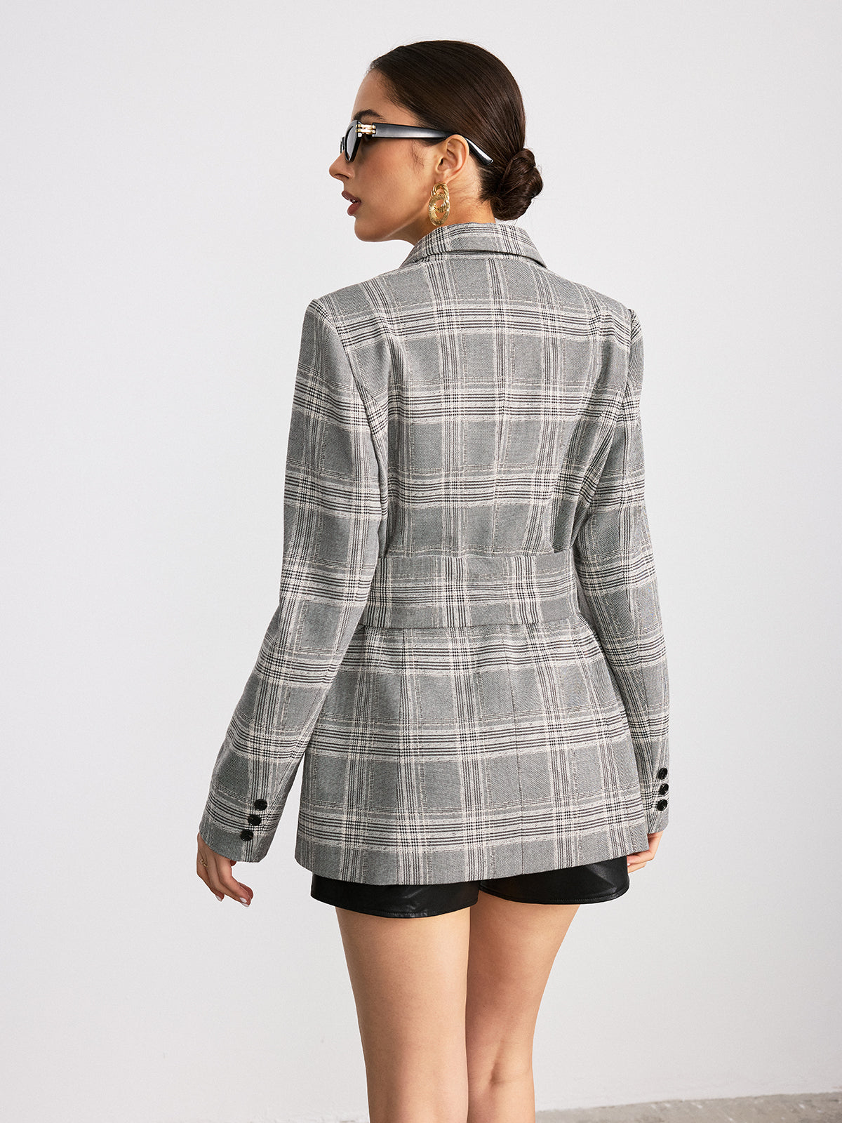Plaid wide belted blazer in cotton mix paired with black shorts.