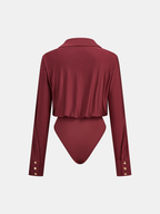 Deep red long sleeve bodysuit with polo collar, buttoned cuffs, cheeky cut, draped jersey.