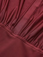 Maroon long sleeve bodysuit with a collar, gathered ruching, and subtle stitched details.