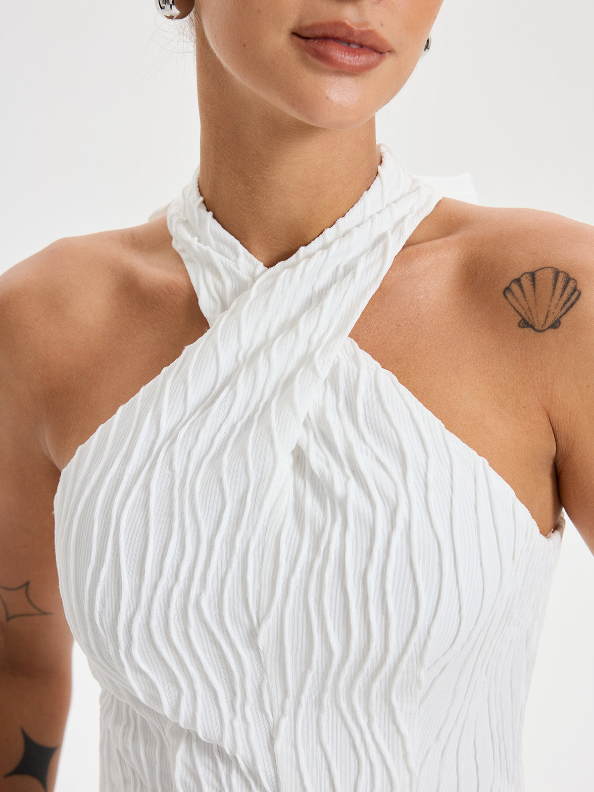 BYPINKYPARIS Crisscross Textured Halter Neck Top, featuring a unique cross-strap design.