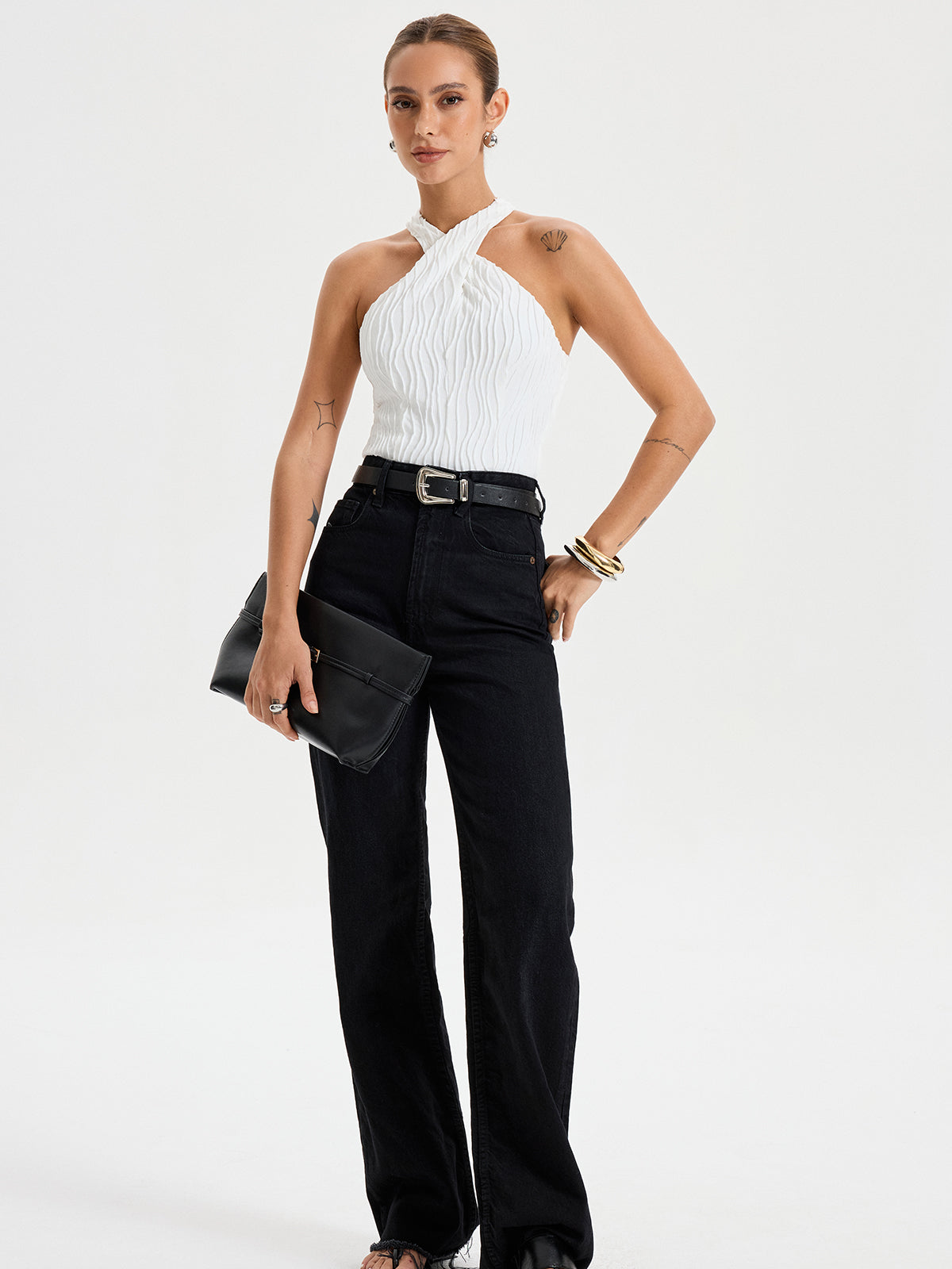 BYPINKYPARIS Crisscross Textured Halter Neck Top paired with high-waisted black jeans.