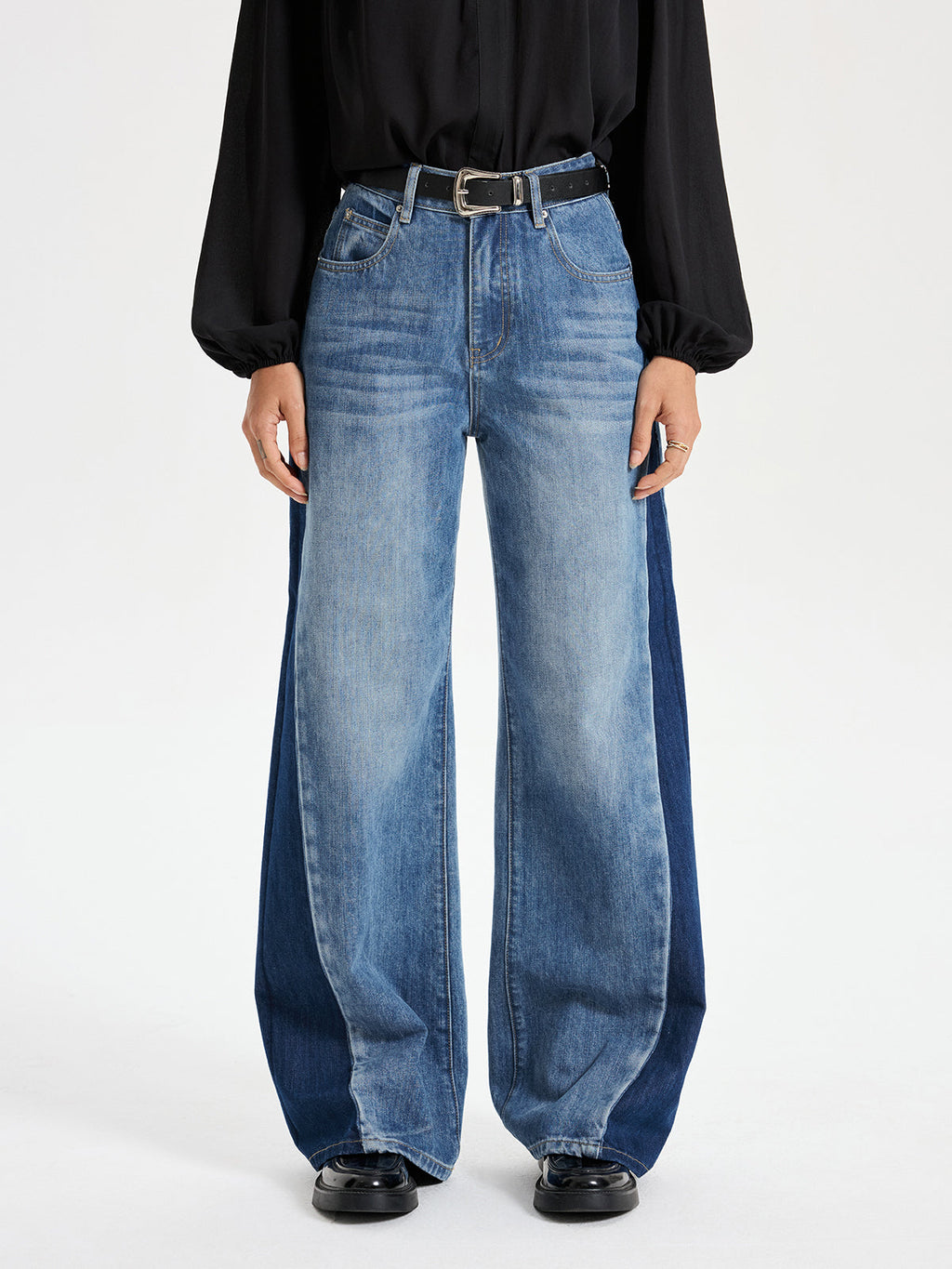 Two-tone wide leg barrel jeans with color-block panels, styled with a relaxed fit.