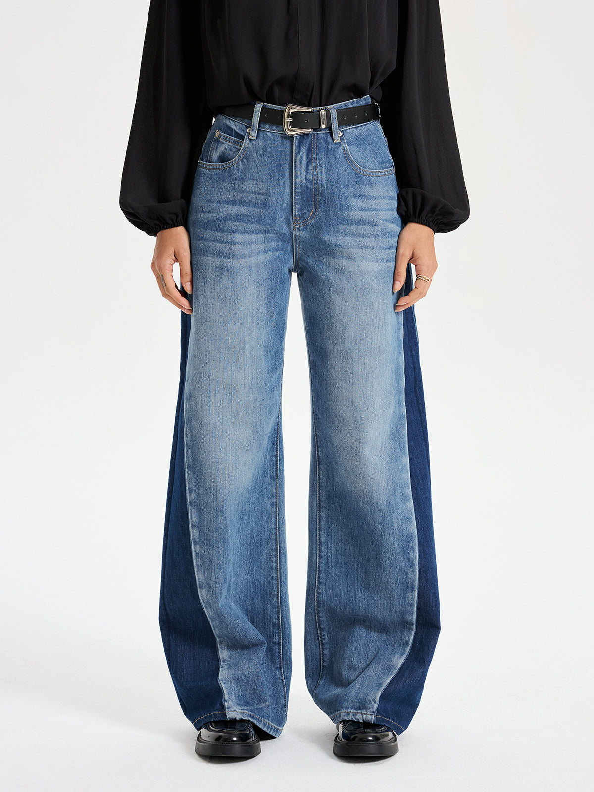 Two-tone wide leg barrel jeans with color-block panels, styled with a relaxed fit.