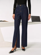 LA FINE FLEUR’s mid-rise jeans with chic side slits, black long-sleeve top, heels.