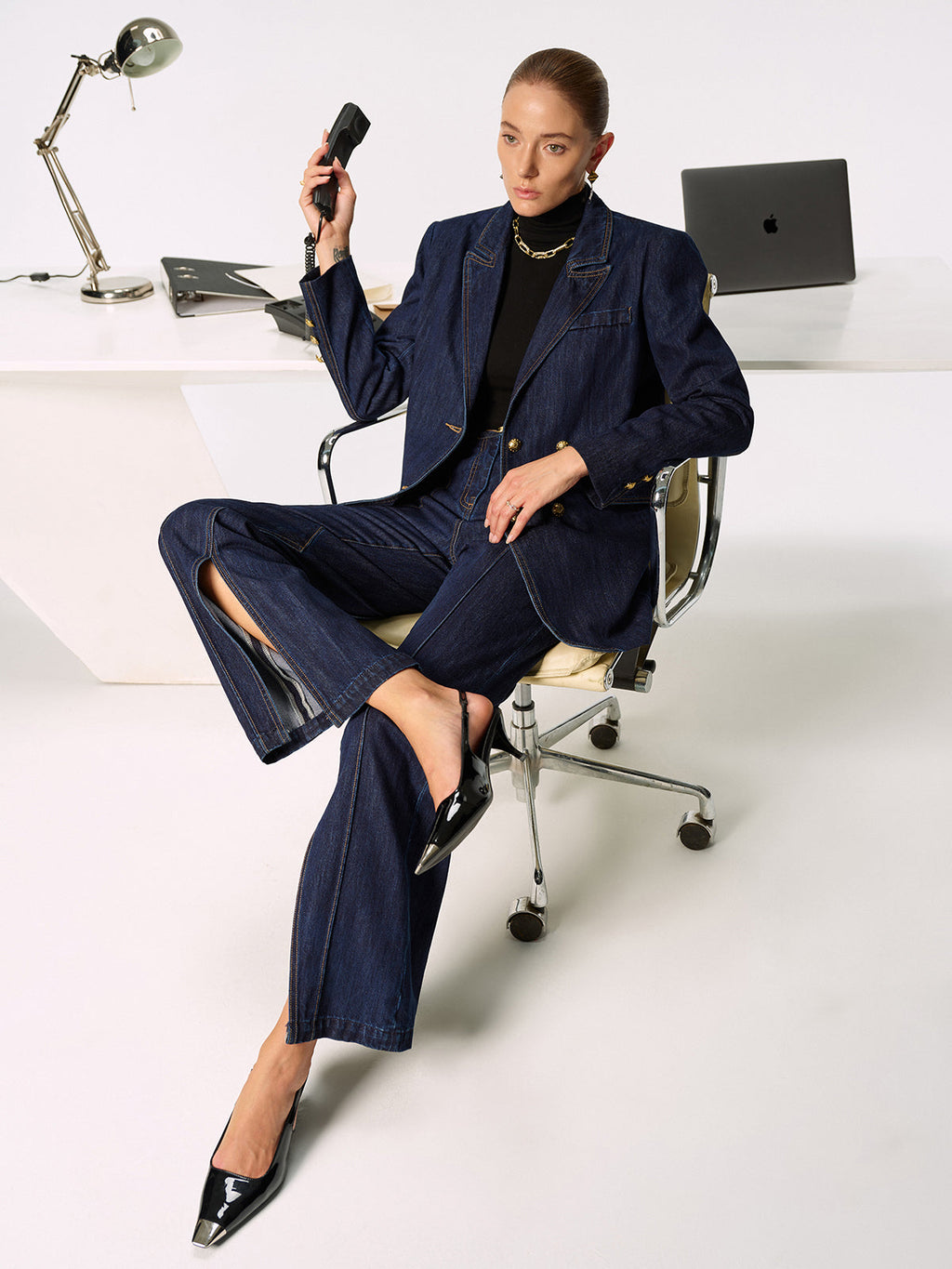 LA FINE FLEUR Mid-Rise Jeans with chic side slits paired with classic black heels.