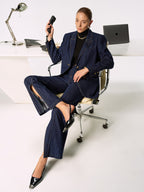 LA FINE FLEUR Mid-Rise Jeans with chic side slits paired with classic black heels.