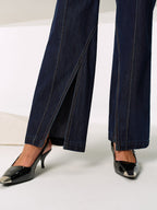 Mid-rise dark navy denim jeans with chic side slits and contrast stitching detailing.