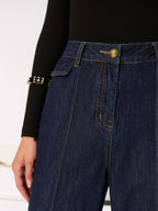 Dark blue LA FINE FLEUR mid-rise jeans with gold stitching and chic side slits.