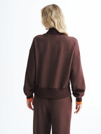 LA FINE FLEUR V-Neck Half-Zip Cozy Pullover Sweatshirt paired with matching brown pants.