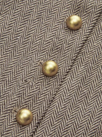 Beige and brown plaid mini dress with pleated skirt and four diagonal gold snap buttons.