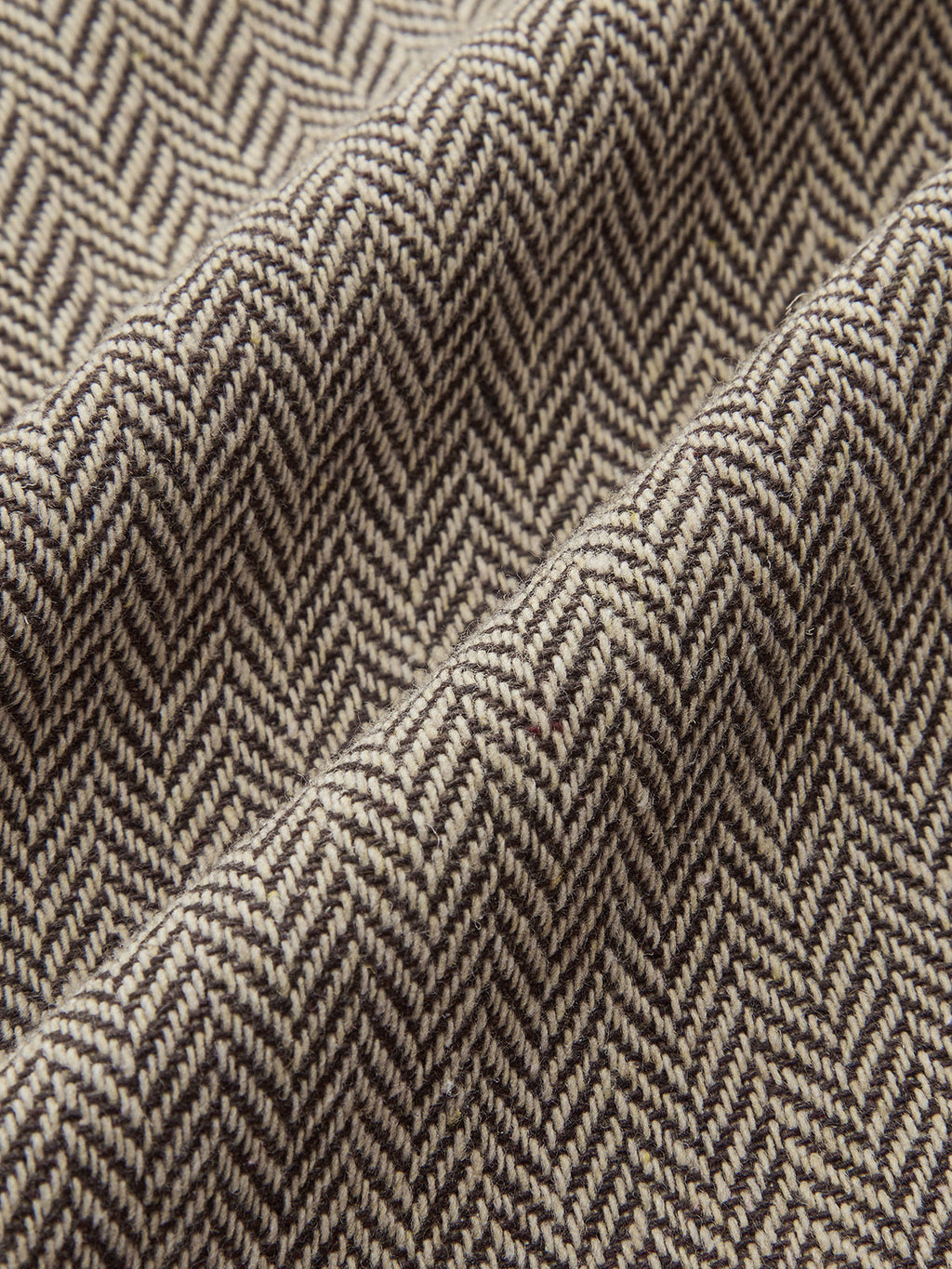 Plaid mini dress with beige and brown herringbone pattern, snap buttons, and pleated skirt.