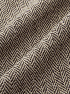 Plaid mini dress with beige and brown herringbone pattern, snap buttons, and pleated skirt.