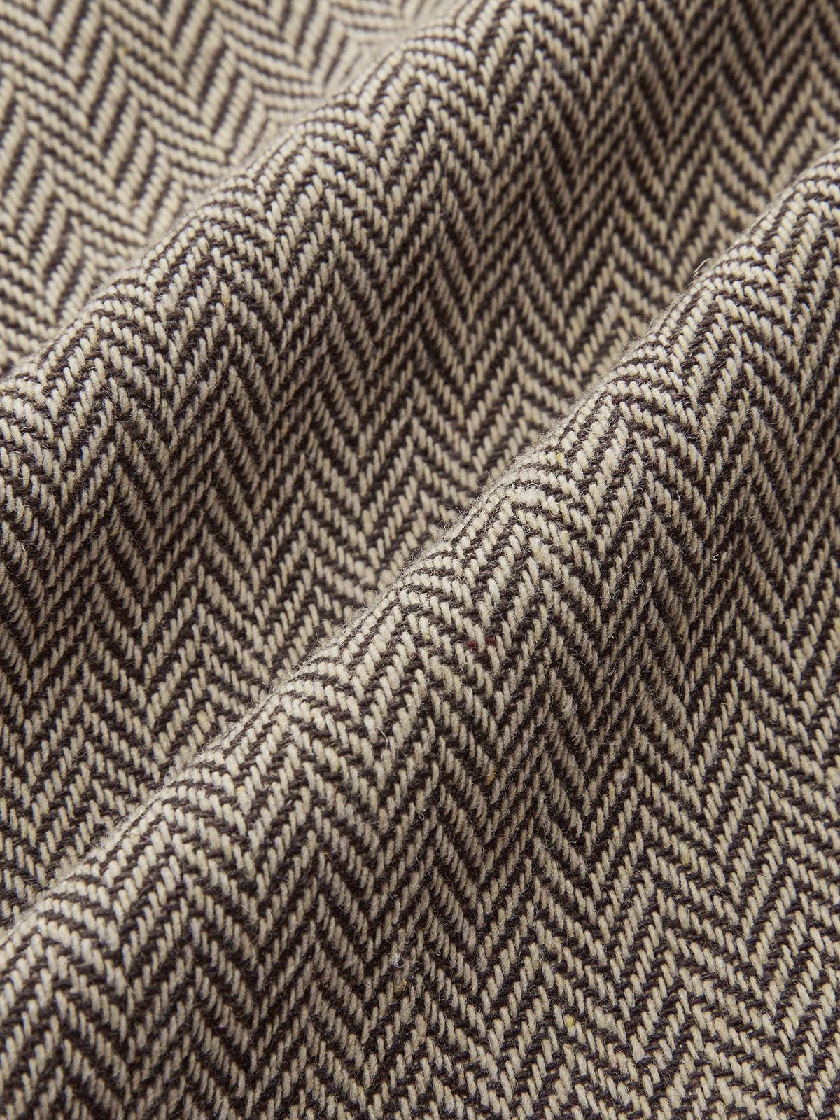 Plaid mini dress with beige and brown herringbone pattern, snap buttons, and pleated skirt.