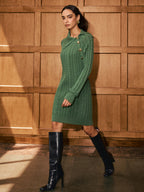 LA FINE FLEUR asymmetric collar sweater dress with cable knit detail, paired with black knee-high heeled boots.