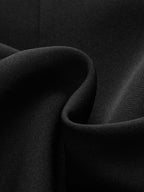 Tailored blazer dress in matte black fabric with soft folds and buttoned collar detail.