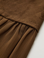 Brown suede-style long skirt with textured band, sheer mesh accents, and flowing pleats.
