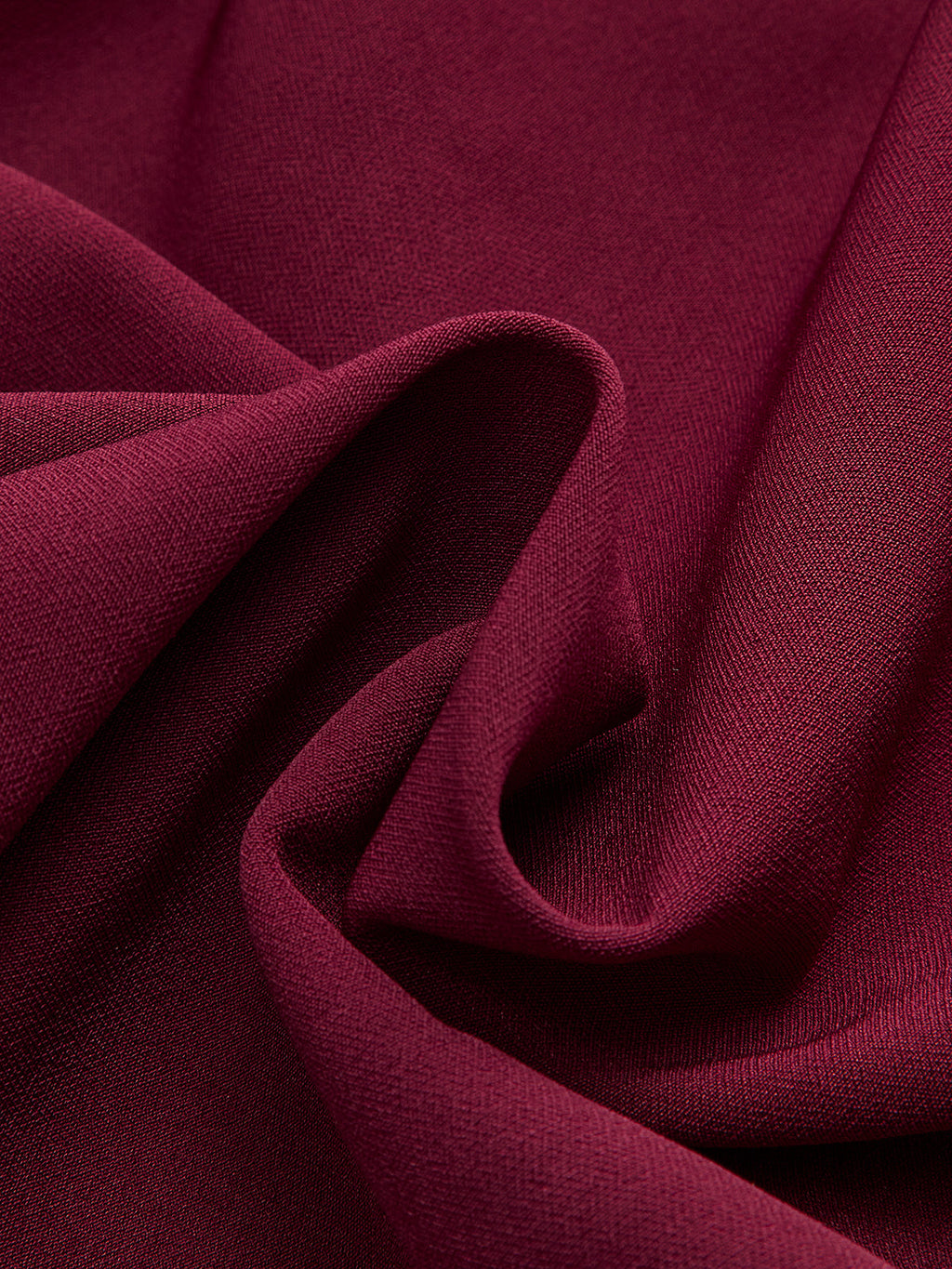 Sleeveless burgundy mini dress with asymmetric ruffle hem, woven fabric, soft folds, subtle texture.