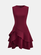 Burgundy sleeveless mini dress with asymmetric ruffle hem, fitted bodice, and layered skirt.