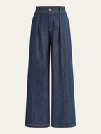 Wide-leg, mid-rise dark blue denim trousers with pleats, belt loops, seams, and ankle-length hem.