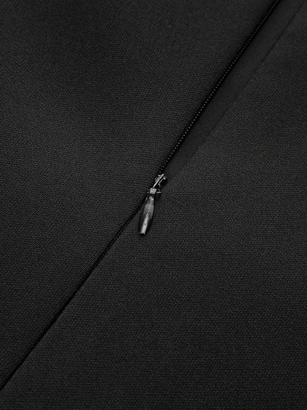 Asymmetric mini dress with pleated hem, metal detail, black woven polyester, and unzipped zipper.