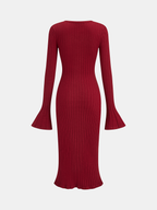 A long-sleeved, ribbed dark red knit midi dress with bell sleeves and mermaid hem.