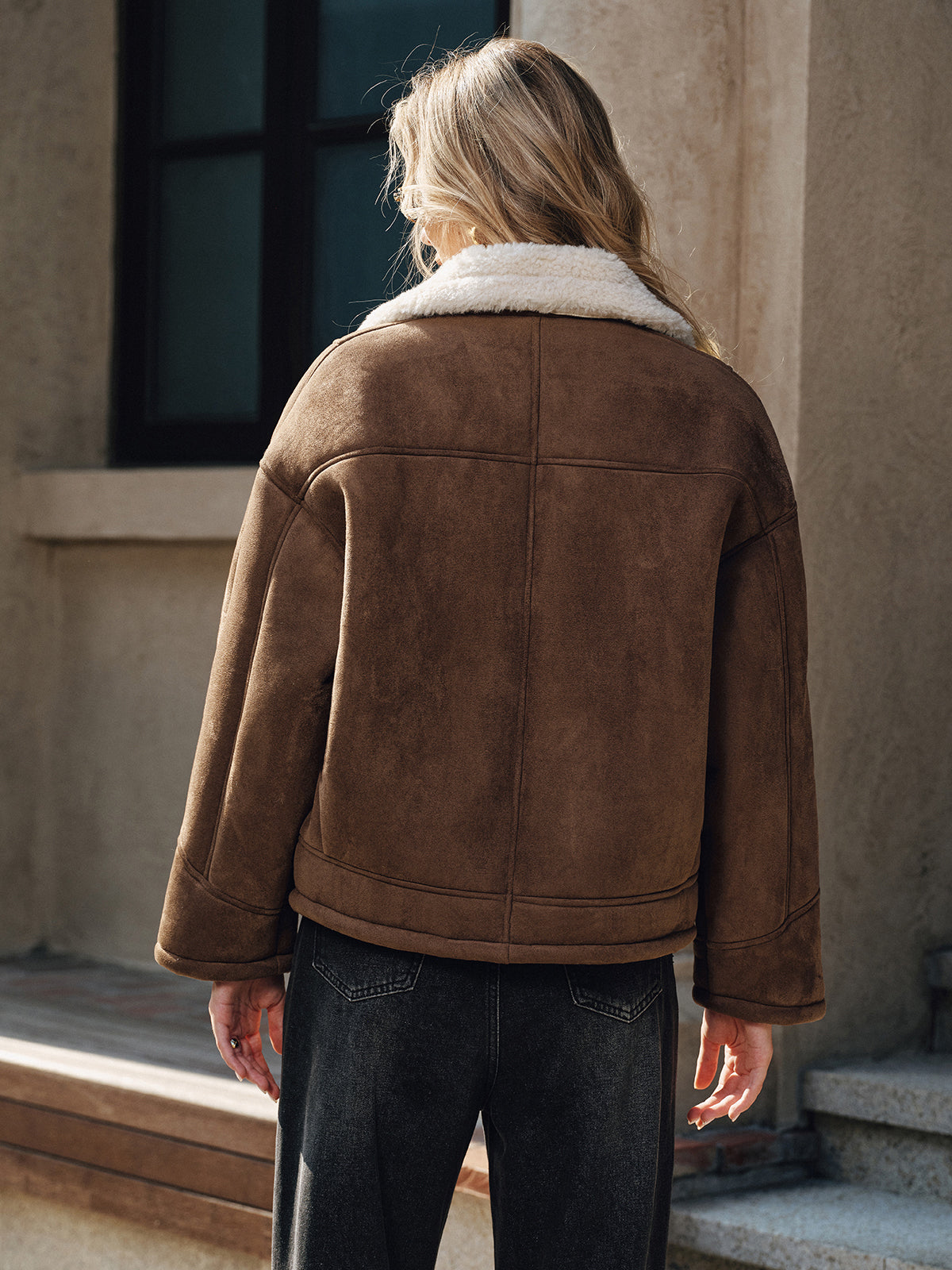 A stylish lapel coat with cozy fleece lining paired with dark jeans.