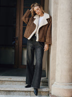 LA FINE FLEUR lapel coat with cozy fleece lining over a white top and black jeans.