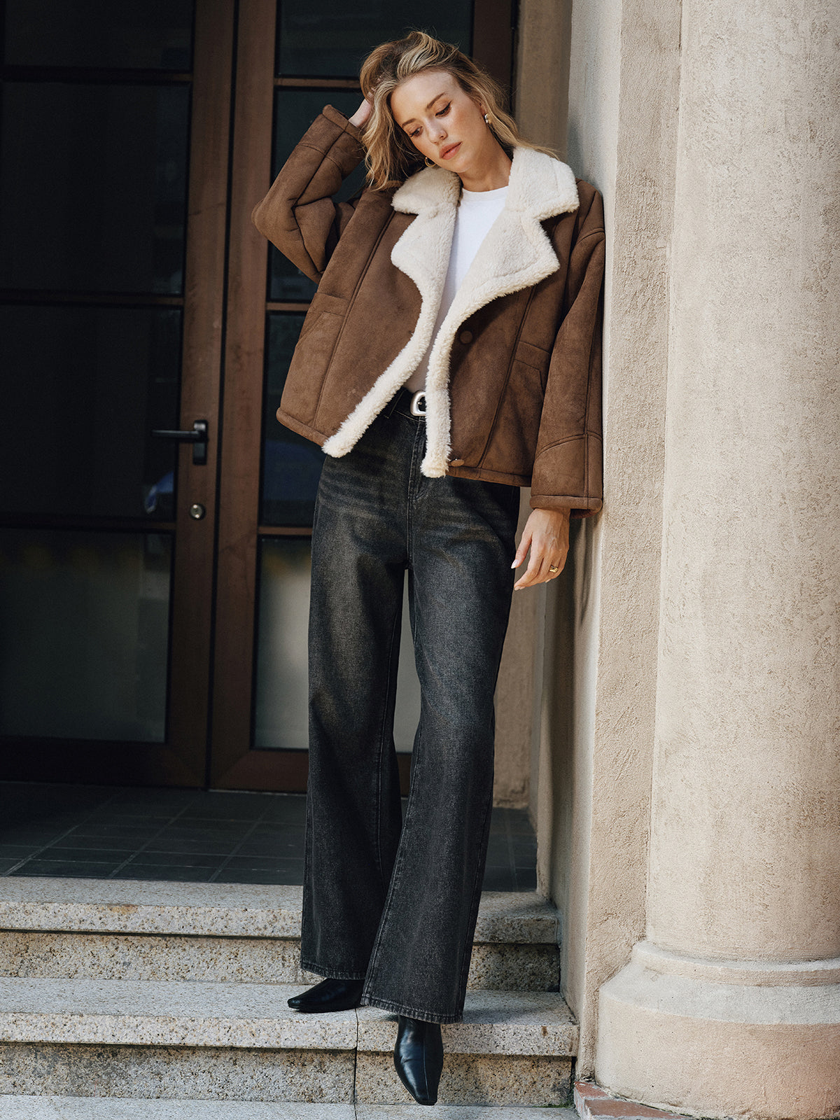 LA FINE FLEUR lapel coat with cozy fleece lining over a white top and black jeans.