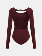 Burgundy long-sleeve bodysuit with backless design, metallic chest buckle, and midriff cut-out.