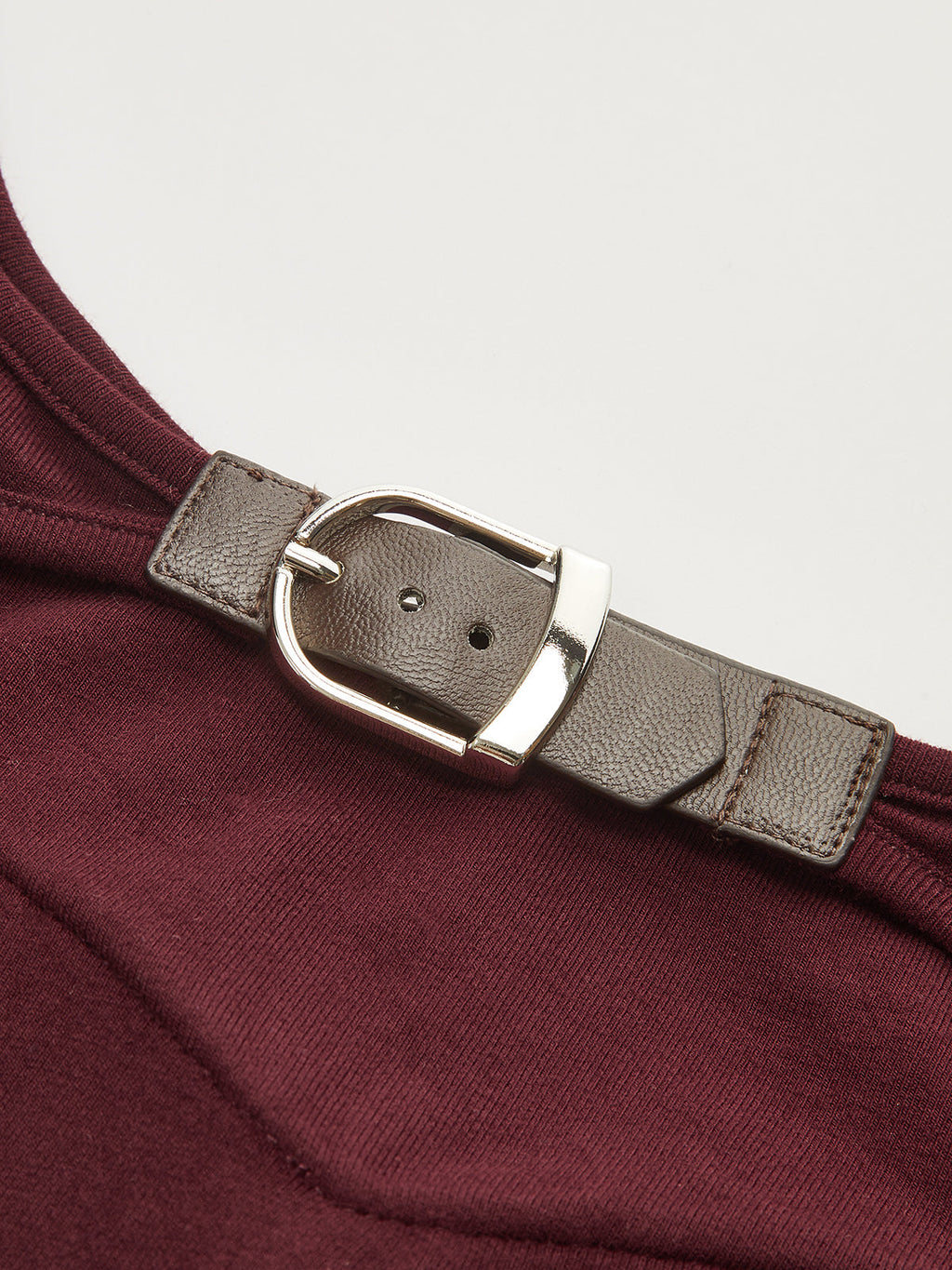 A backless long-sleeve bodysuit with buckled detail and textured, slim-fitting fabric.