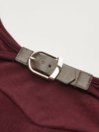 A backless long-sleeve bodysuit with buckled detail and textured, slim-fitting fabric.