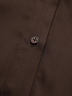 Ribbed knit shirt dress with brown collar, belted panel, and buttoned front detail.