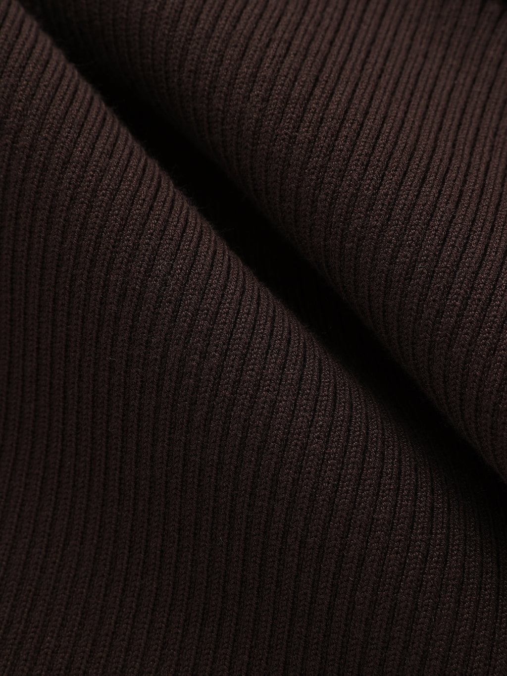 Close-up of a dark brown ribbed knit shirt dress with vertical textured lines and folds.