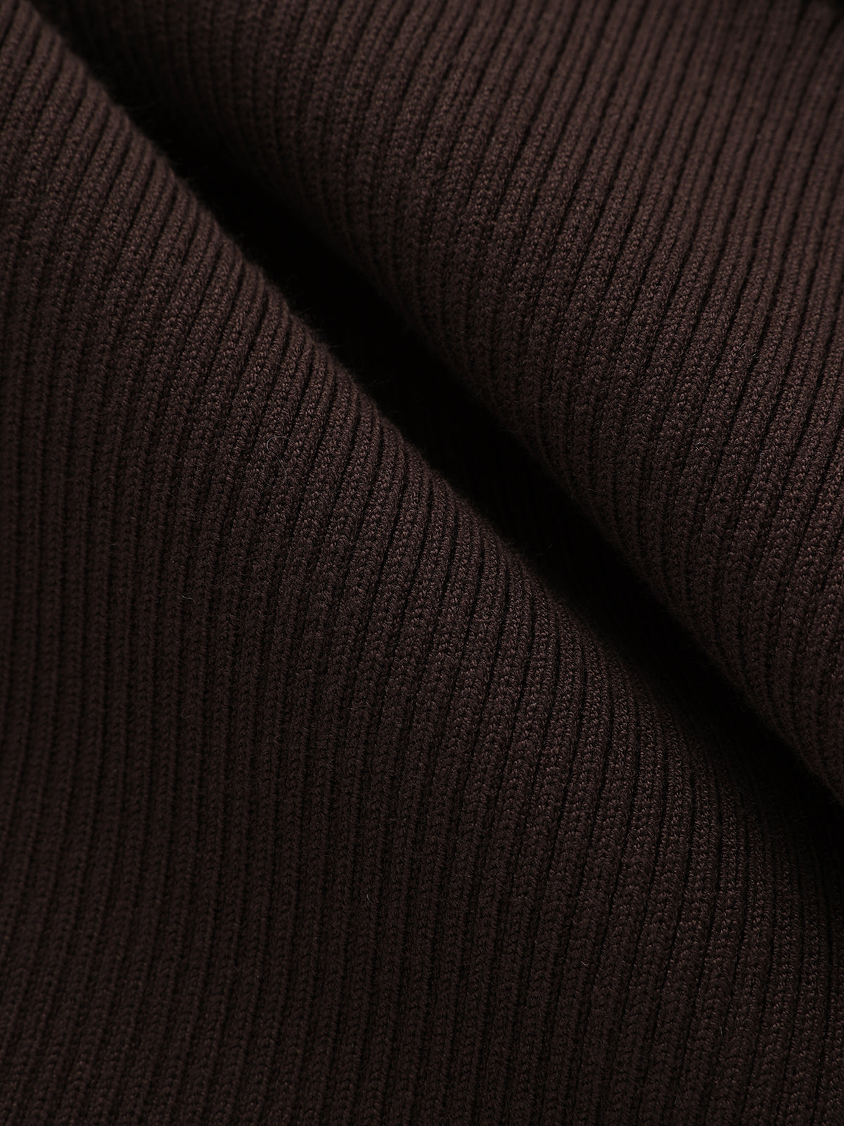 Close-up of a dark brown ribbed knit shirt dress with vertical textured lines and folds.