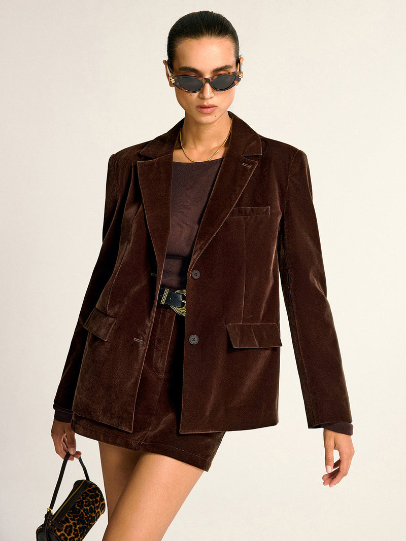 Elegant velvet shawl collar blazer with matching skirt and a simple brown top.